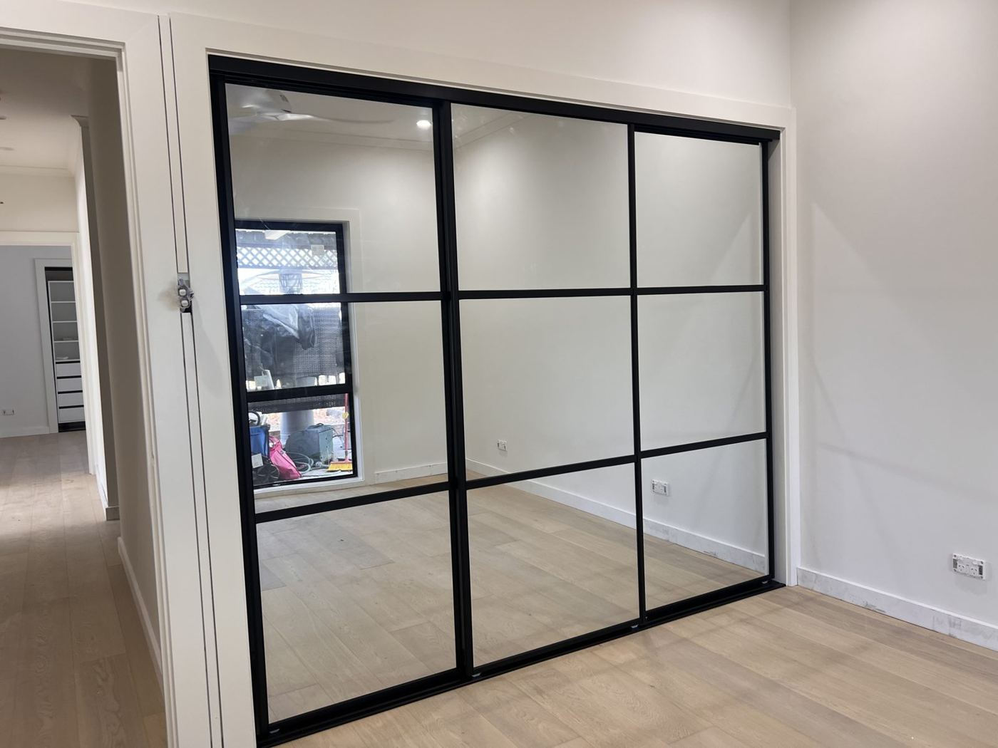Black-framed glass wardrobe doors