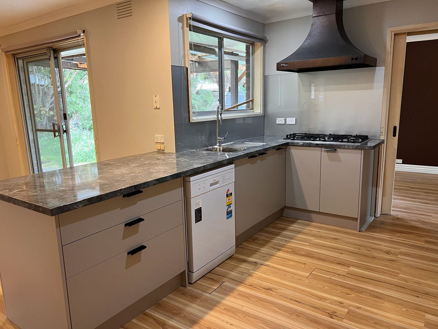 Renovated kitchen with stone benchtop and grey cabinets